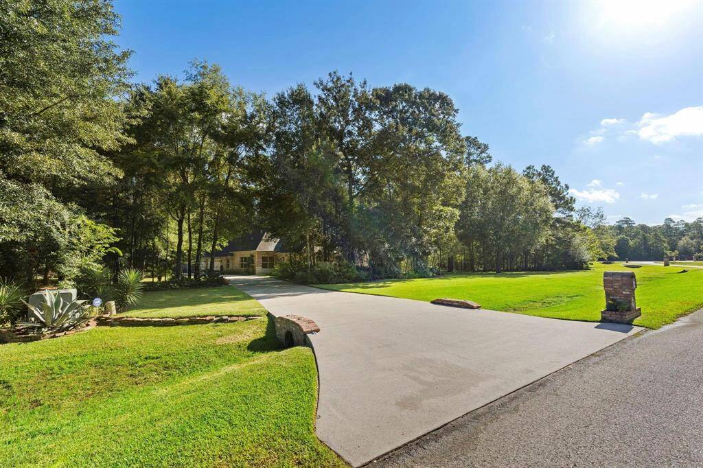 Single driveway entrance opens up in the back for 2-3 cars as well as garage parking.