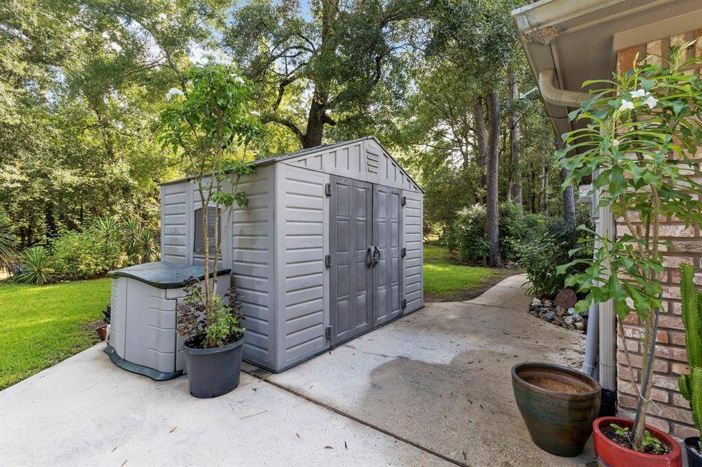 Storage shed to side of garage.