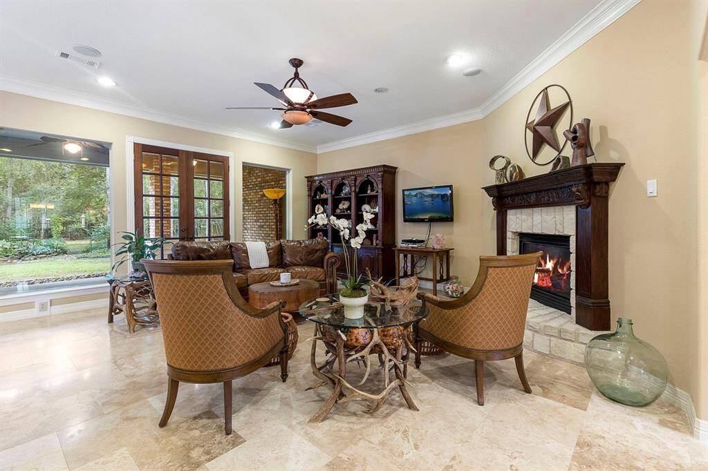 Living room with fireplace, large picture windows let so much natural light in.