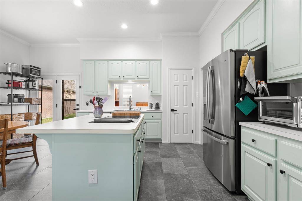 French doors in kitchen open to back yard.  LOVE the light in this home!
