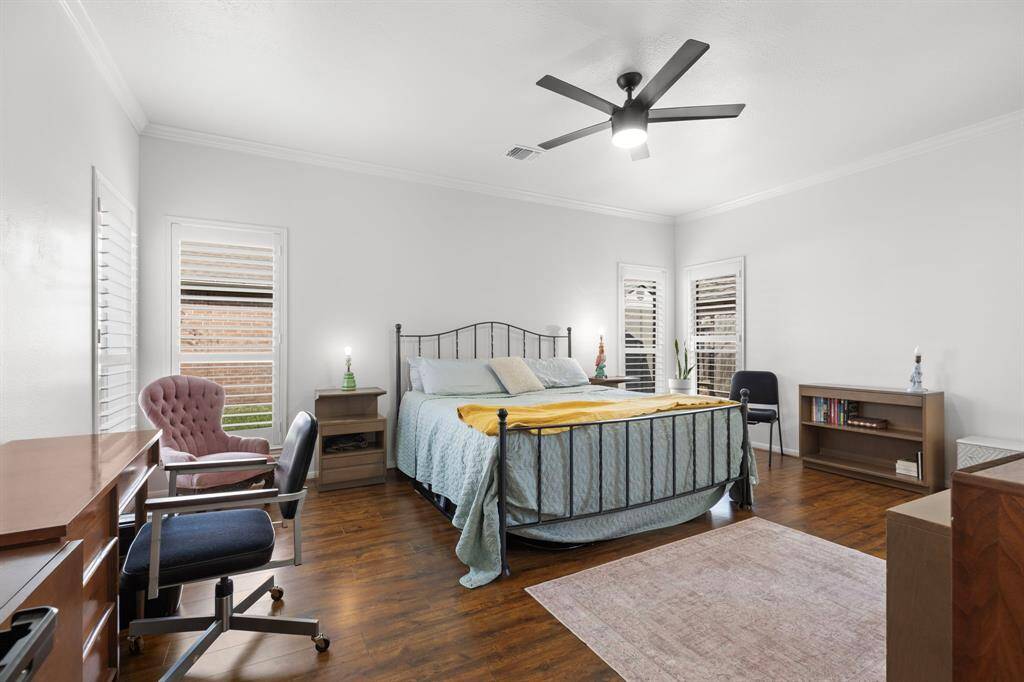 Primary retreat with wood laminate flooring and nice views into the backyard.
