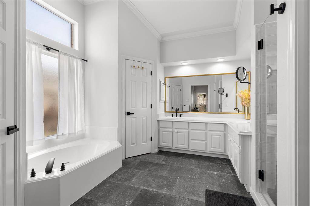 Pimary bathroom with with soaking tub and remodeled shower with frameless shower door and new tile.  Slate tile flooring!