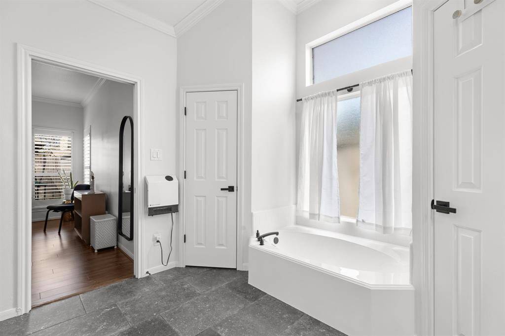 Primary bathroom with slate floors and nice soaking tub.