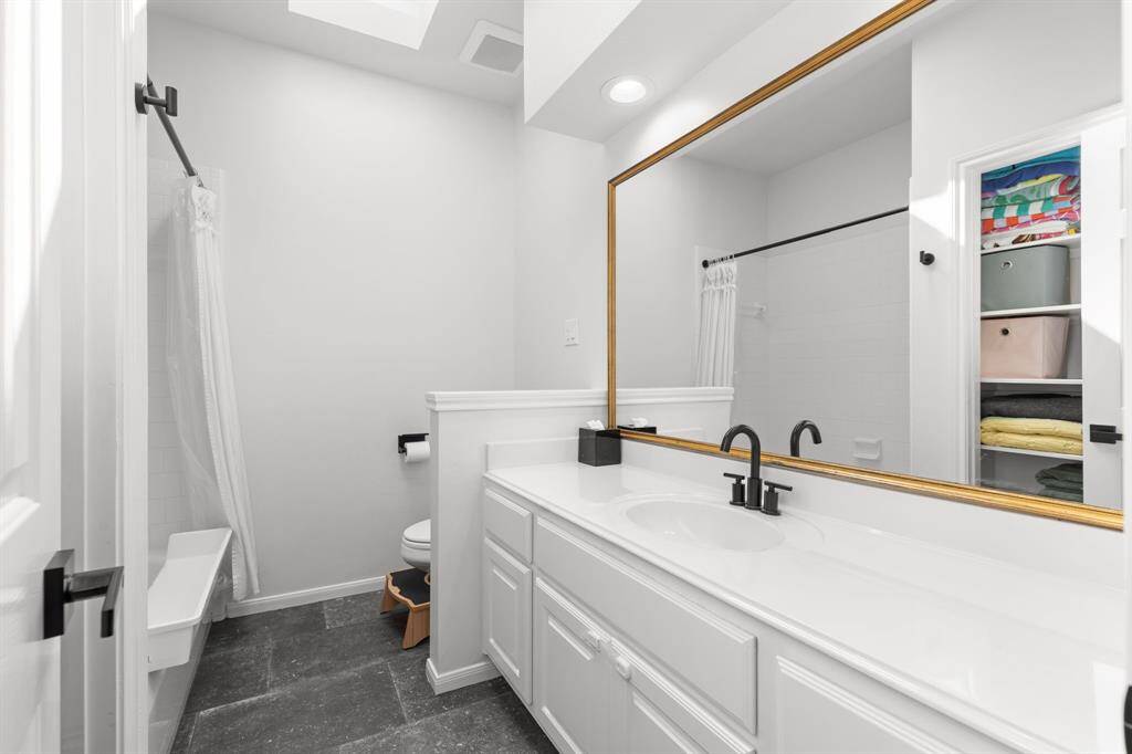 Secondary bathroom with slate tile floors and new fixtures.  Home has a water softner and new water heater.