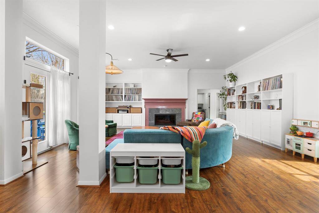 Nice high ceilings and a wall of windows and doors on both sides of this family room make it light and bright year round.
