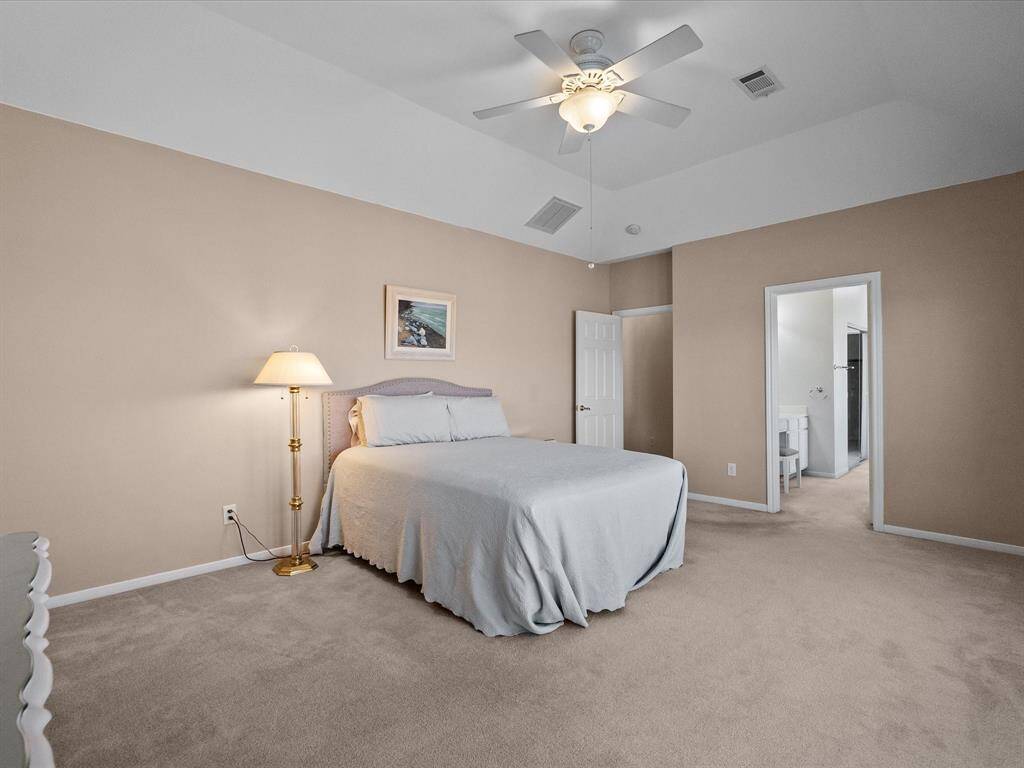 Generous primary suite with a stunning wall of windows for abundant natural light.