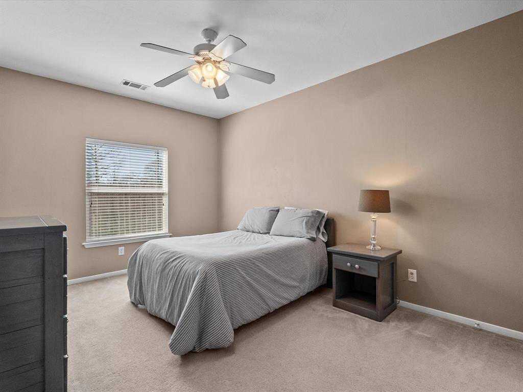 Roomy secondary bedroom featuring a walk-in closet and a comfortable layout.