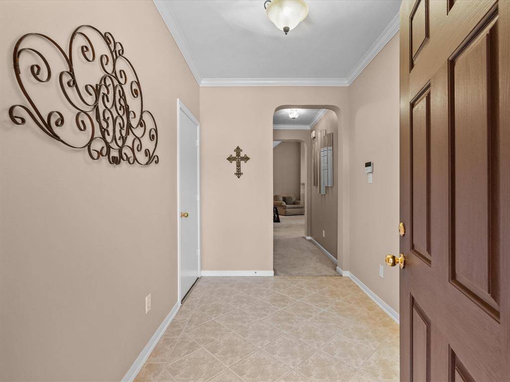 Welcoming foyer with a high ceiling and arched enrtyway in to the main living areas.