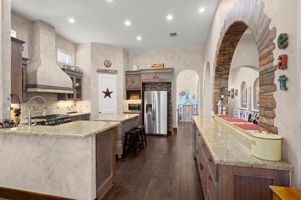 Kitchen with granite countertops and breakfast bar.