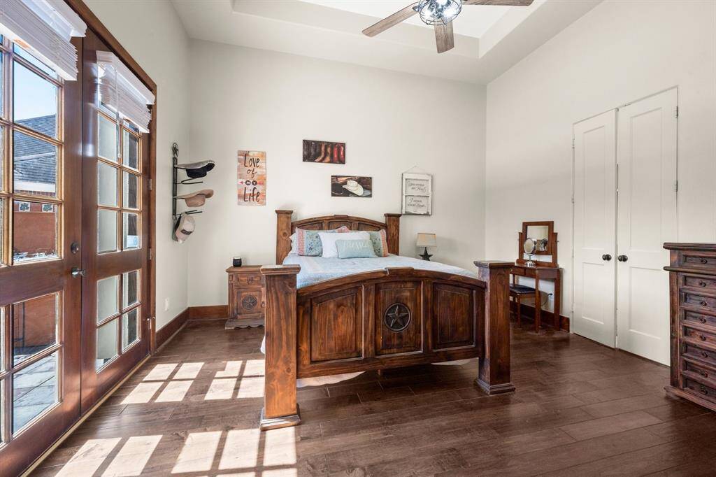 Primary bedroom with doors to private patio.