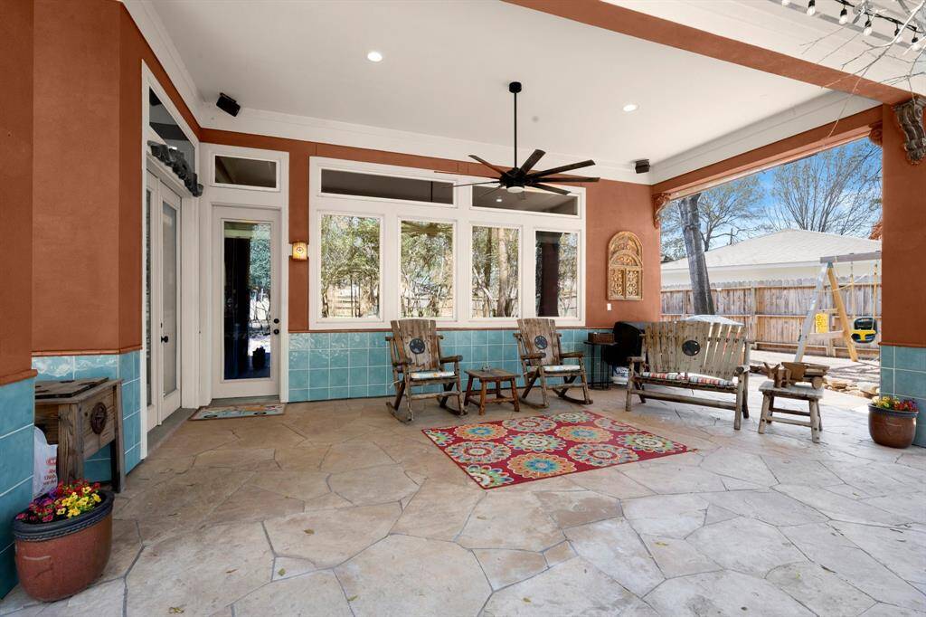 Large covered back patio facing beautiful back yard.