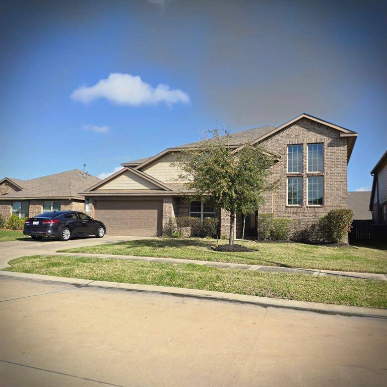 Charming brick home with a spacious two-car garage and lush front yard. Ideal curb appeal in a welcoming neighborhood.