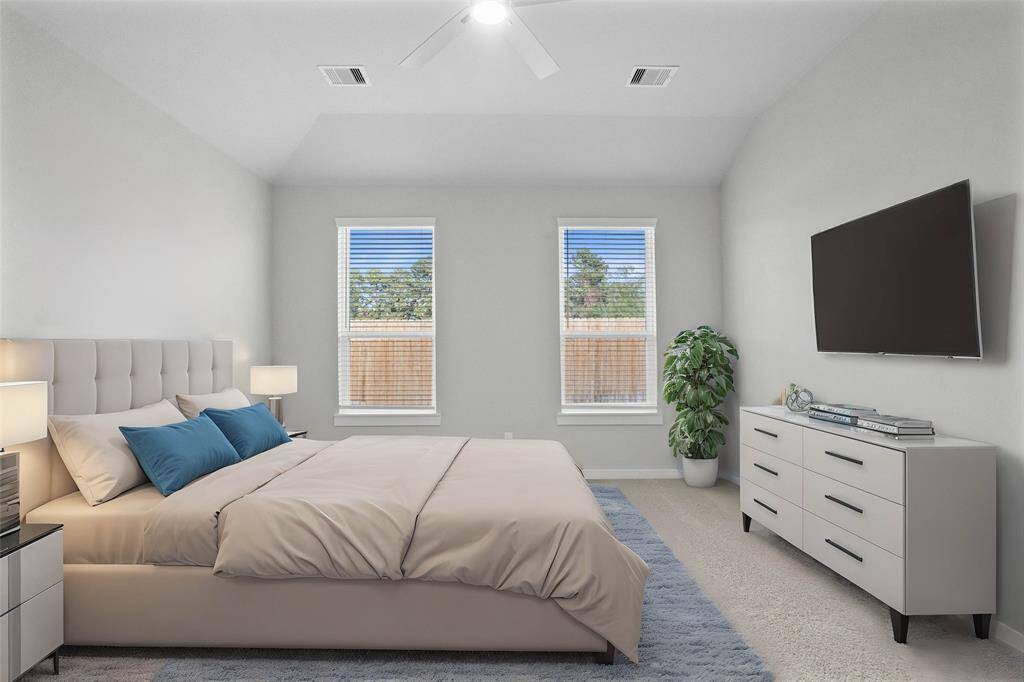 Come and unwind after a long day in this magnificent primary suite! This spacious room features plush carpet, warm paint, ceiling fan, high ceilings and large windows with privacy blinds.