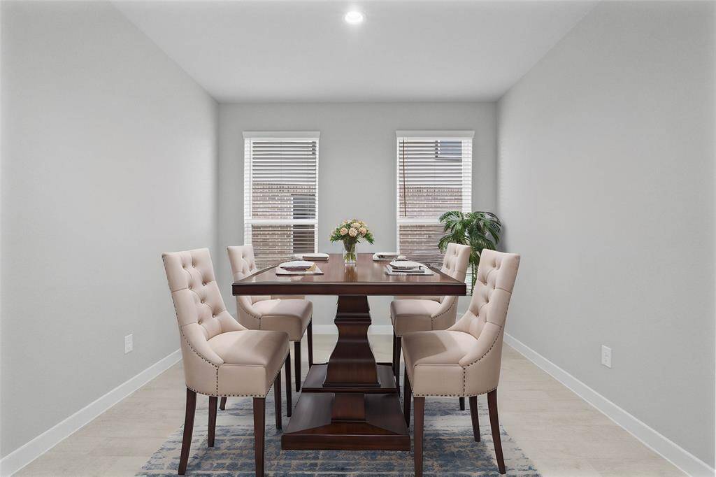 Make memories gathered around the table with your family and friends! This dining room features high ceilings, large windows with privacy blinds, tile flooring and recessed lighting!