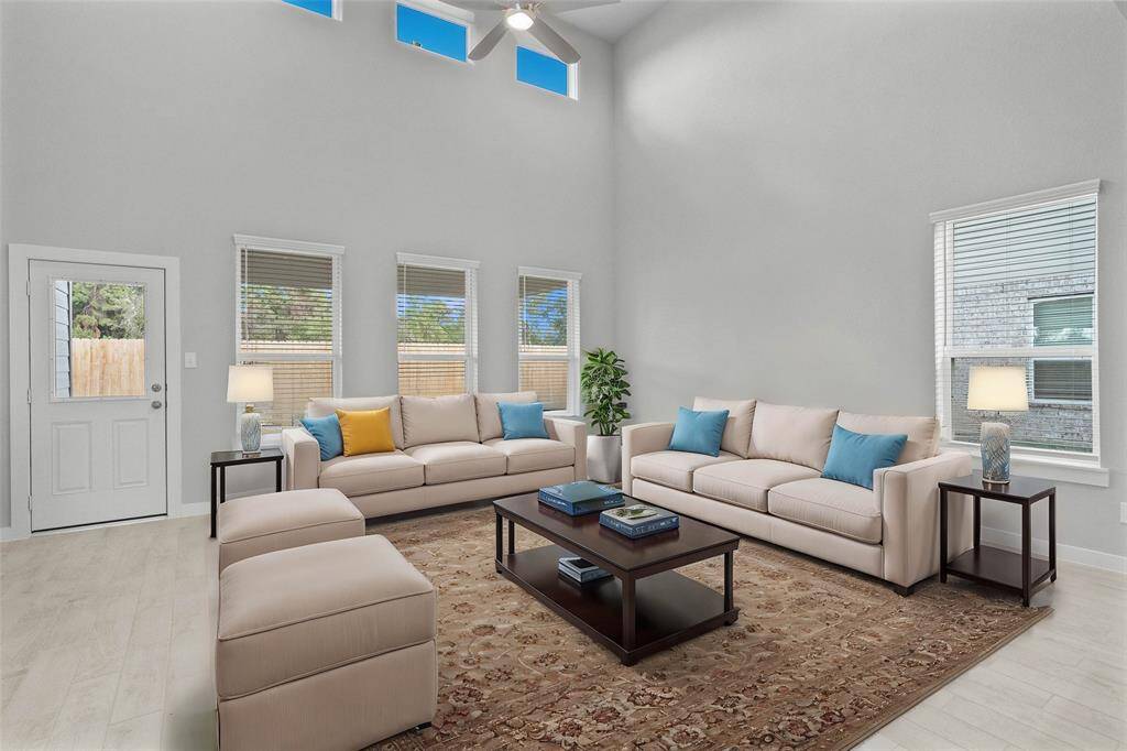 Gather the family and guests together in your lovely family room! Featuring soaring high ceilings, recessed lighting, ceiling fan, custom paint, gorgeous floors and large windows that provide plenty of natural lighting throughout the day.