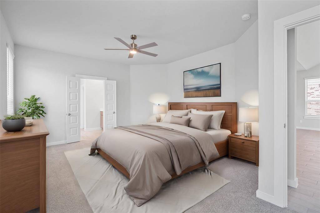 Come and unwind after a long day in this magnificent primary suite! This spacious room features plush carpet, warm paint, high ceilings, ceiling fan, and large windows with privacy blinds!