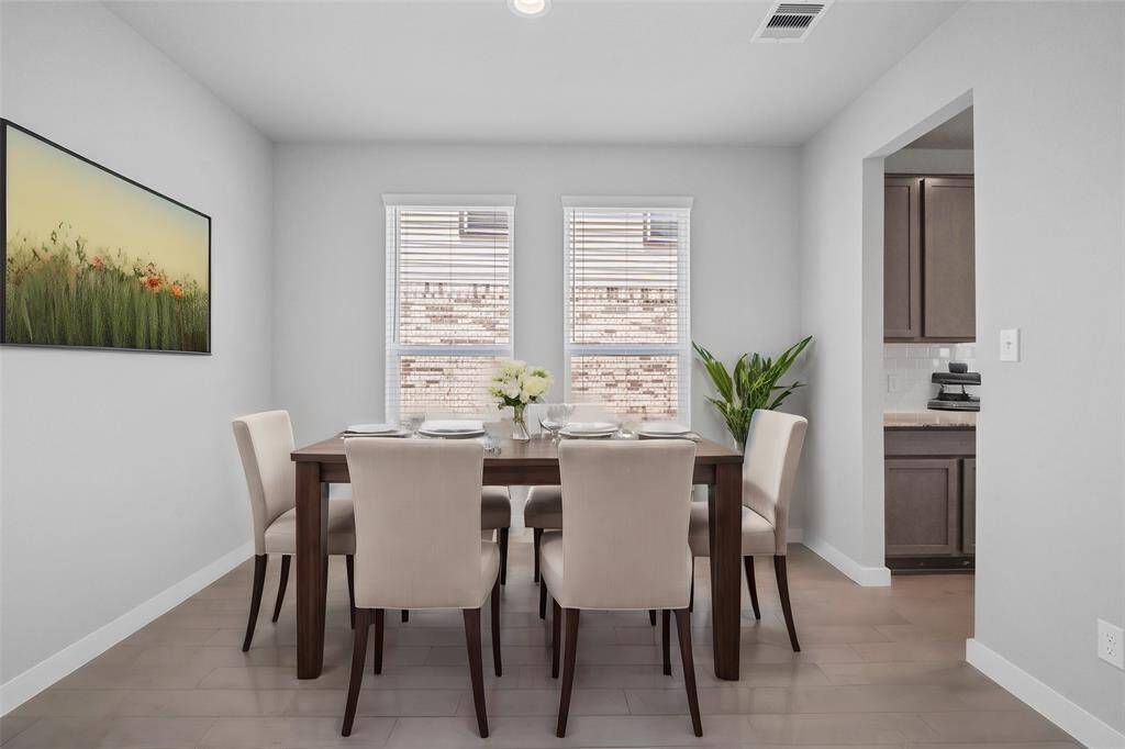 You and your guests will certainly dine in style in this amazing formal dining room! Featuring large windows with privacy blinds, neutral paint, high ceilings, and tile flooring! Perfect space to entertain family and friends!