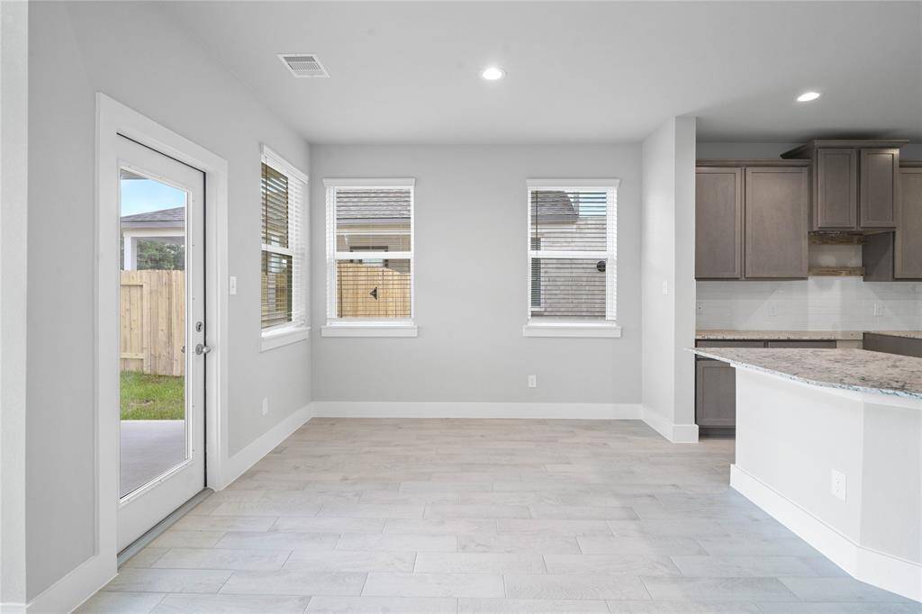 Start your day off right with a cup of coffee sitting with your family in the lovely breakfast area! Featuring large windows with blinds, custom neutral paint, recessed lighting and high ceilings.