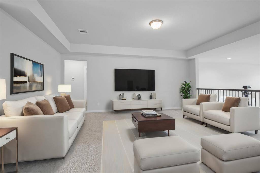 Come upstairs and enjoy a day of leisure in this fabulous game room! This is the perfect hangout spot or adult game room, this space features plush carpet, high ceiling, lighting, custom paint and open to the downstairs.
