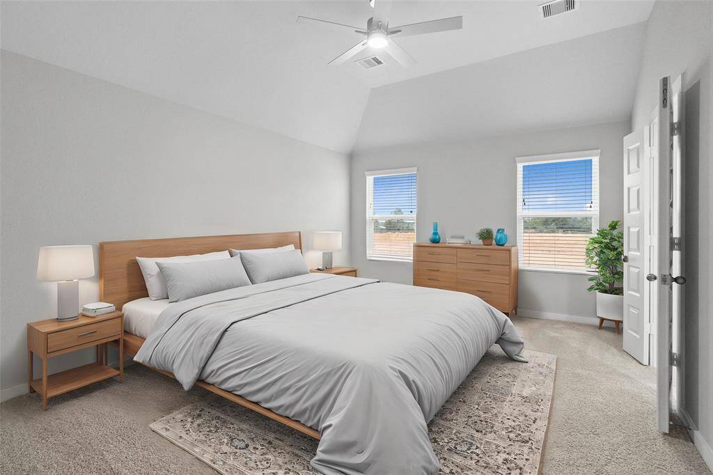 What a wonderful place to come home to, this stunning primary suite greets you with plush carpet, a warm custom paint, high ceiling with ceiling fan, lovely windows with privacy blinds allowing in natural light brightening up this spacious bedroom.