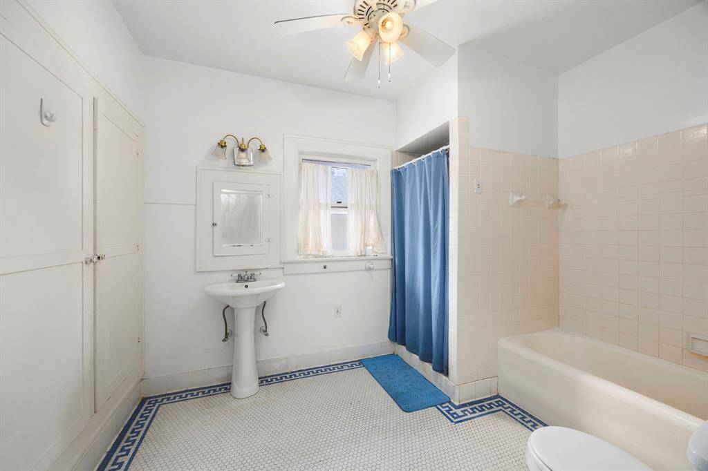 Conveniently located at the top of the stairs, this second-floor bathroom offers excellent remodeling potential. Very large with a lot of room to work with.