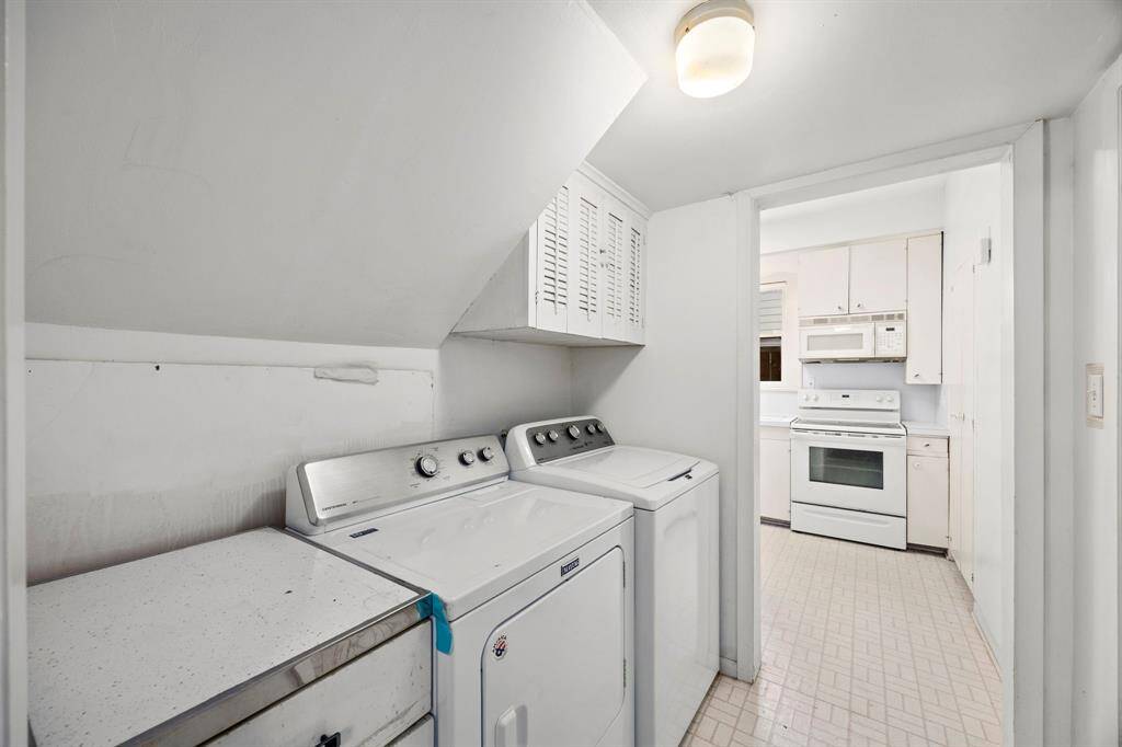 Compact laundry area with washer and dryer, conveniently located next to the kitchen. Potential to convert into a walk-in pantry or cozy coffee nook.