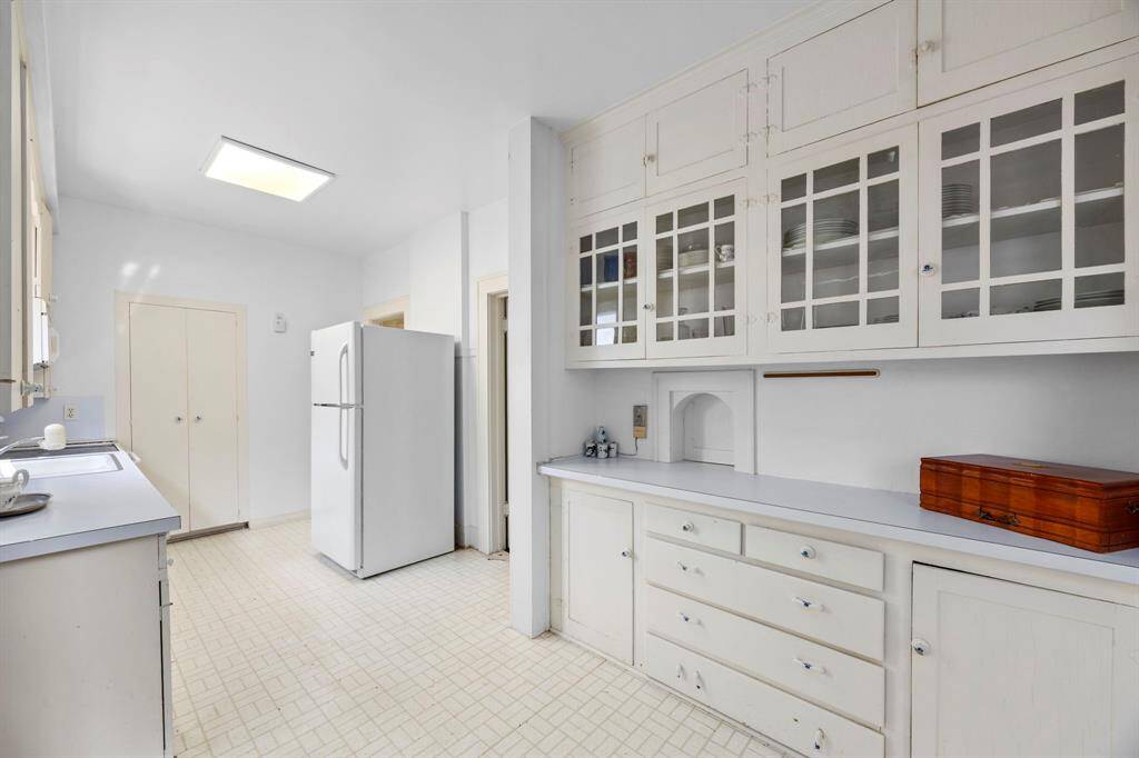 Transform the kitchen into your dream culinary haven by opening up the space—remove the cabinet wall for a seamless, spacious design that opens into the living room.