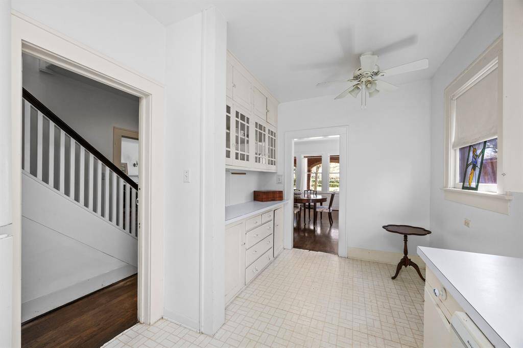 Open up the kitchen by removing the cabinet wall, creating a seamless flow to the stairs and living room.