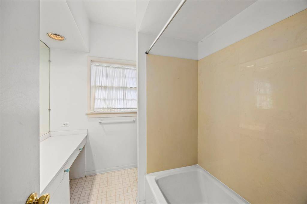 Spacious first-floor full bathroom with excellent remodel potential.