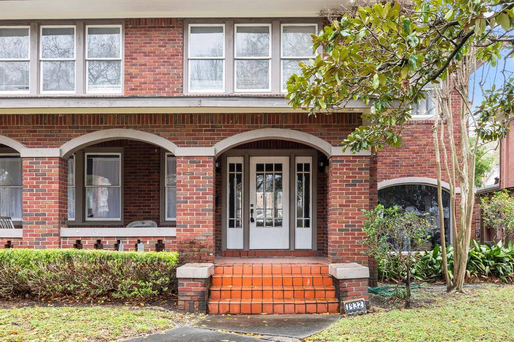 Stately facade with brick exterior and a covered patio.