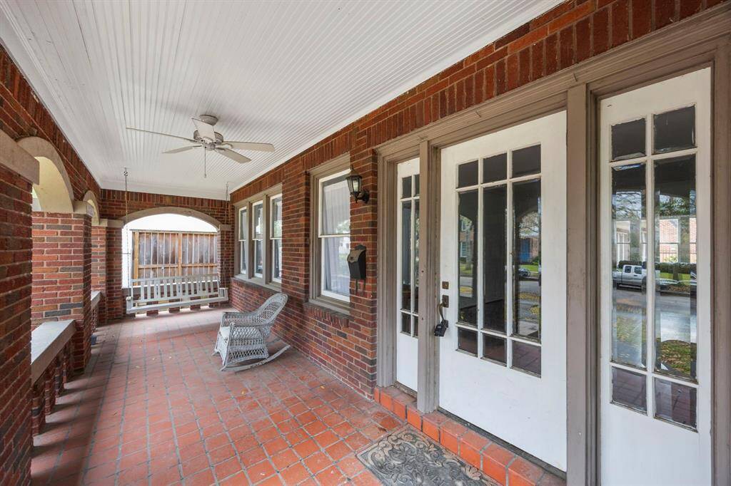 Charming historic home offers incredible renovation potential, featuring a spacious front porch with classic brick arches, and a prime location—perfect for buyers looking to restore its timeless beauty or reimagine it with modern updates.