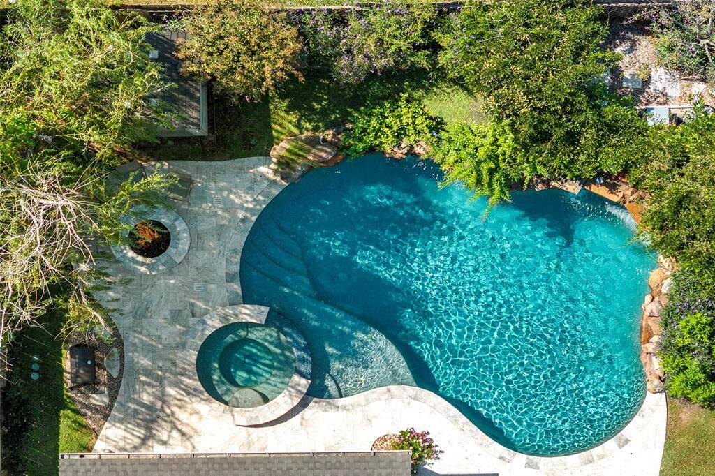 This aerial view shows you the private oasis that is just yours to enjoy with those you hold dear! Wonderful trees and gorgeous travertine surround the sparkling water!