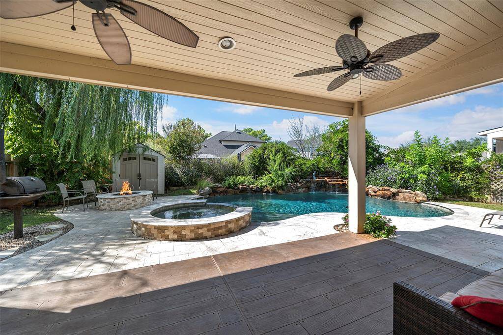 Step out onto the covered patio and sit beneath the breezy ceiling fans overlooking your backyard oasis!  Spectacular stamped concrete looks like wood!