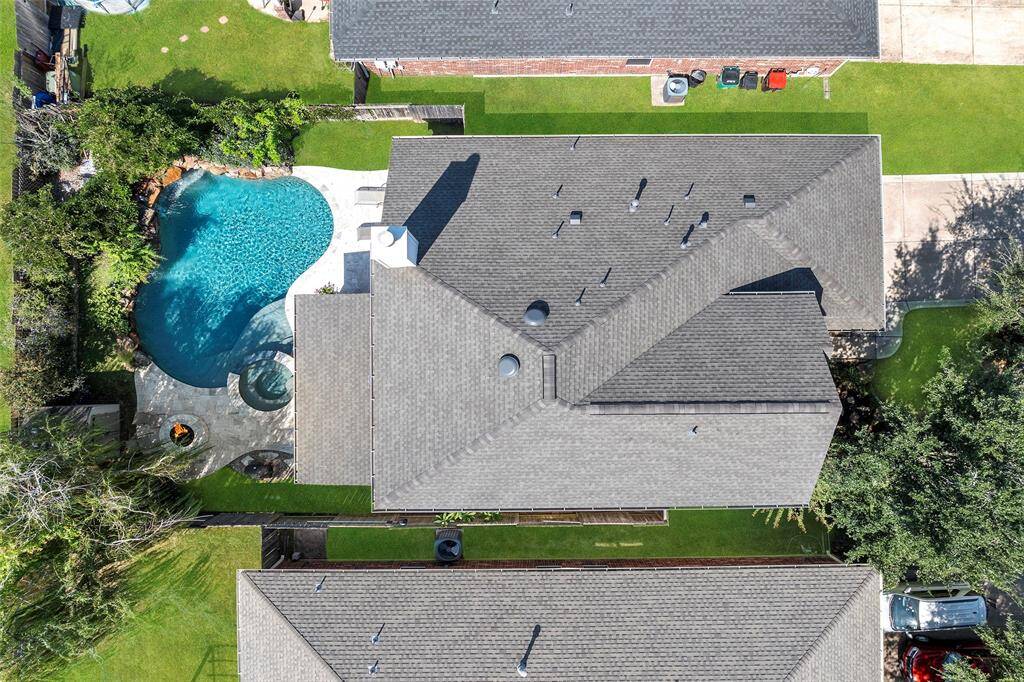 This aerial view shows the recently installed room (2024), along with the FABULOUS outdoor entertainment area this home offers!
