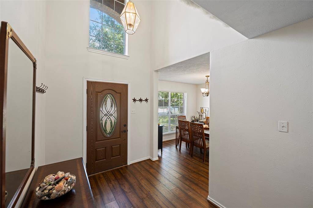 Open the door to a light and bright home! The light flows into the entry from the formal dining, the front door and the window perched above!