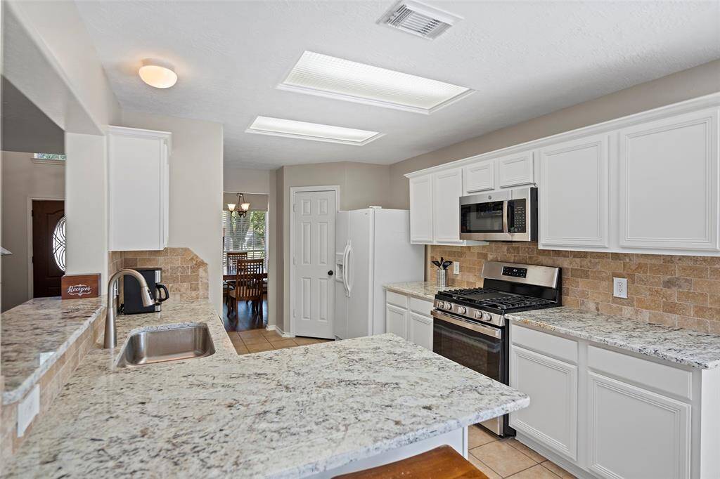 A wonderfully updated kitchen awaits the chef of the home! Freshly painted cabinets offer storage and are adorned with gorgeous granite countertops!