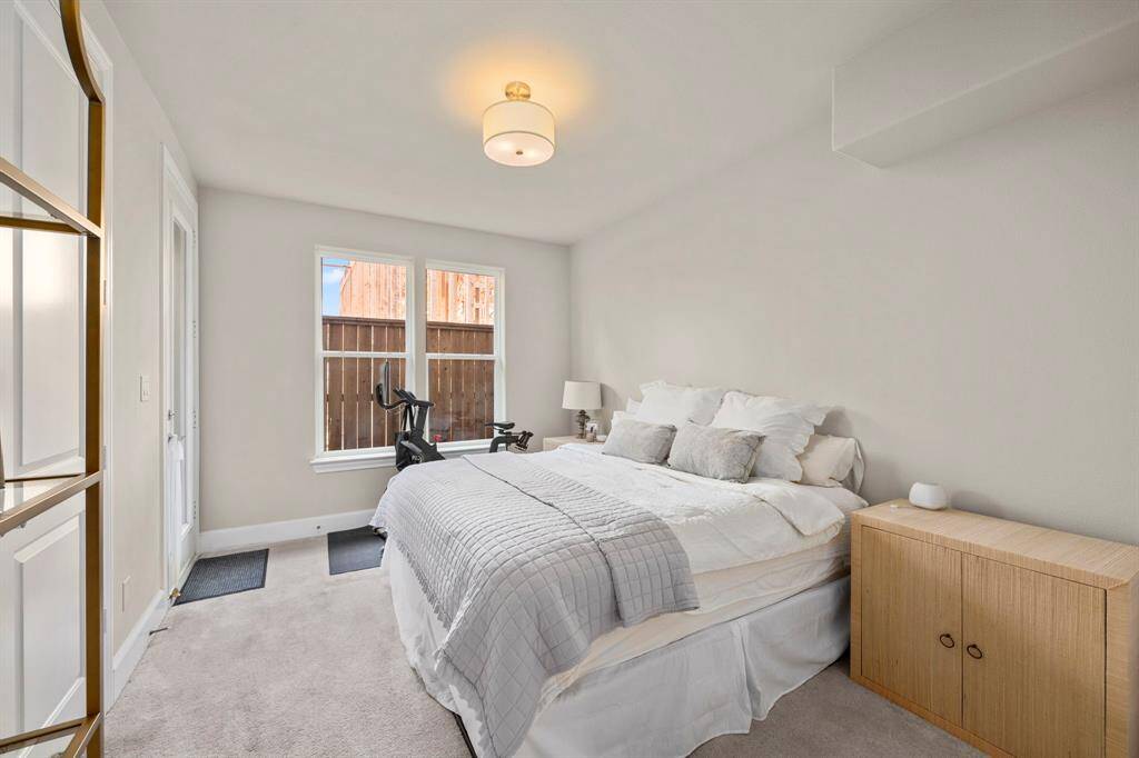 First floor bedroom with private bathroom and backyard access.