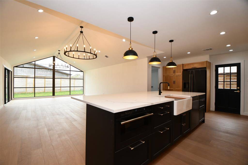 The main area of this contemporary home feautes catherdral ceiling, over sized candeliers plus a kitchen for the most sophisticated of chefs.
