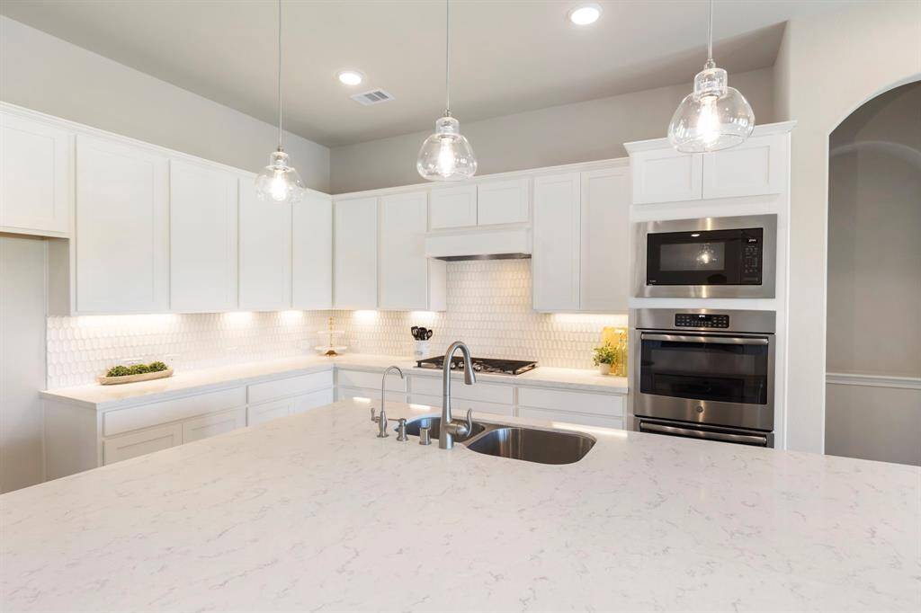 Ample countertop space for meal prep and entertaining, complemented by double ovens and a 5-burner cooktop!