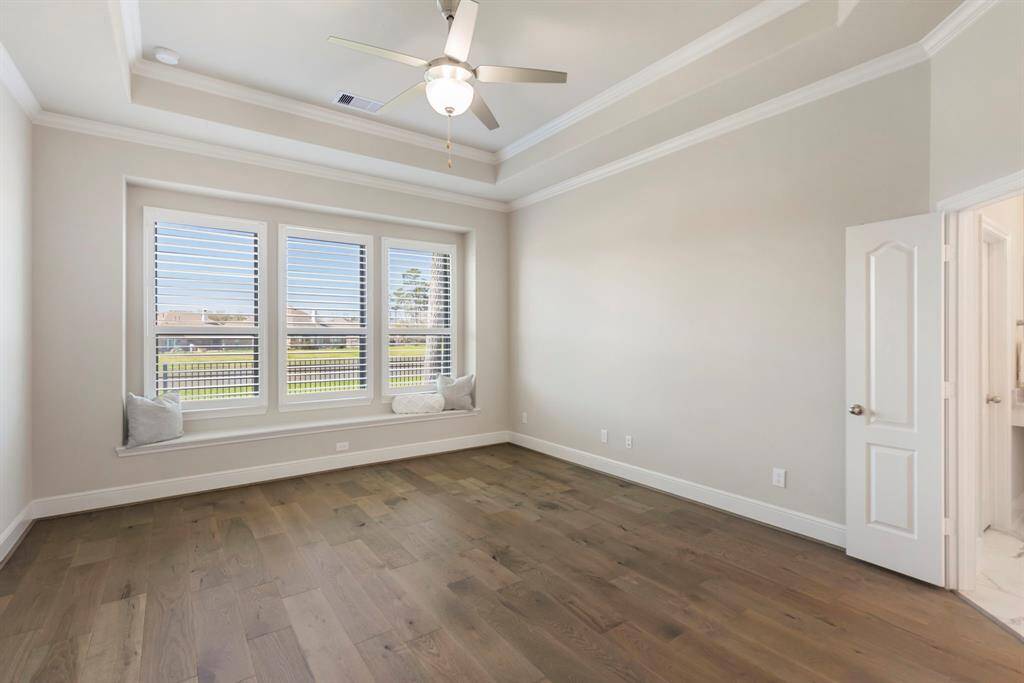 Another angle of the serene Primary Retreat, showcasing its double-door entry to the luxurious ensuite bathroom.