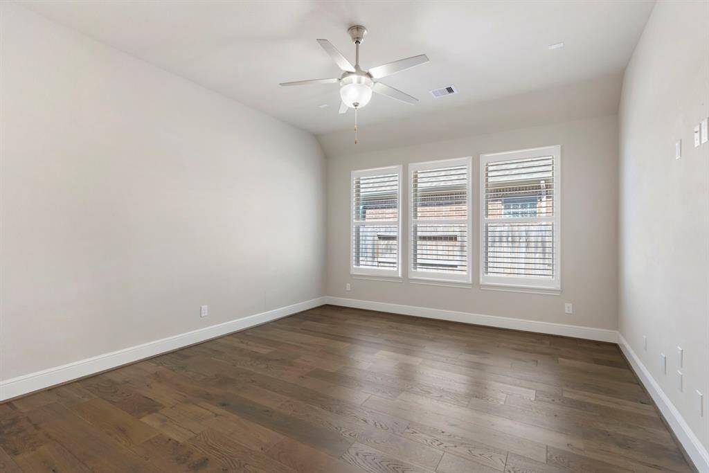 A rare find! This first-floor Game Room, conveniently located off the Family Room, offers endless possibilities—use it as a playroom, media space, or even a home gym. Featuring a wall of windows, a ceiling fan, and surround sound wiring, this versatile space is ready to suit your needs!