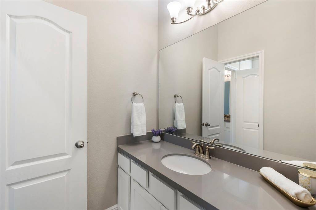 The other side of the Jack-and-Jill bathroom features a spacious vanity with ample storage.