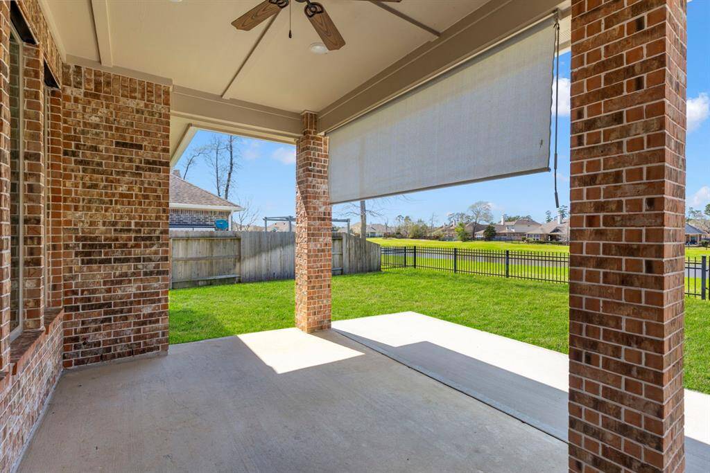 The back patio with a sun shade, ceiling fans, and already wired for a mounted tv!