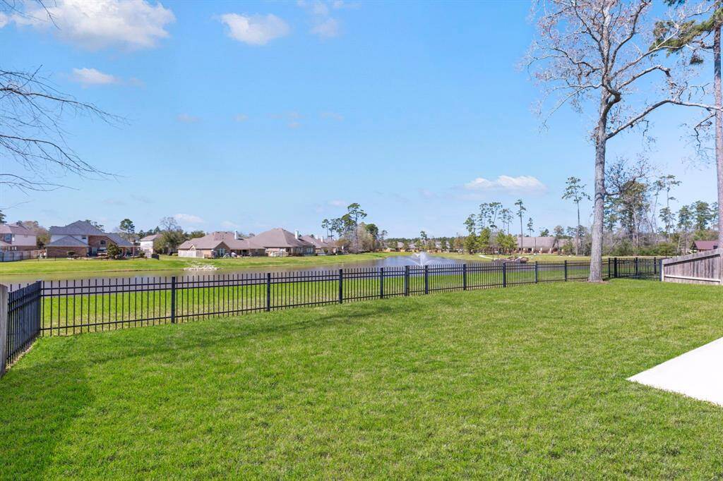 Your own tranquil retreat with wrought iron fencing along the back of the property allowing for a seamless view of the lake and beautiful evening sunsets!