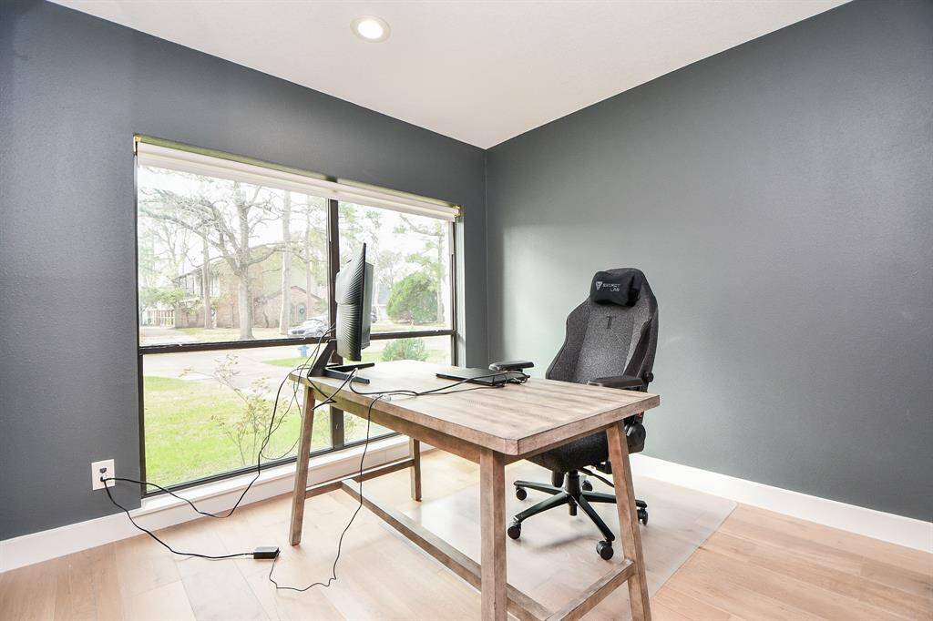Bright and inviting study with large windows, perfect for productivity and relaxation.