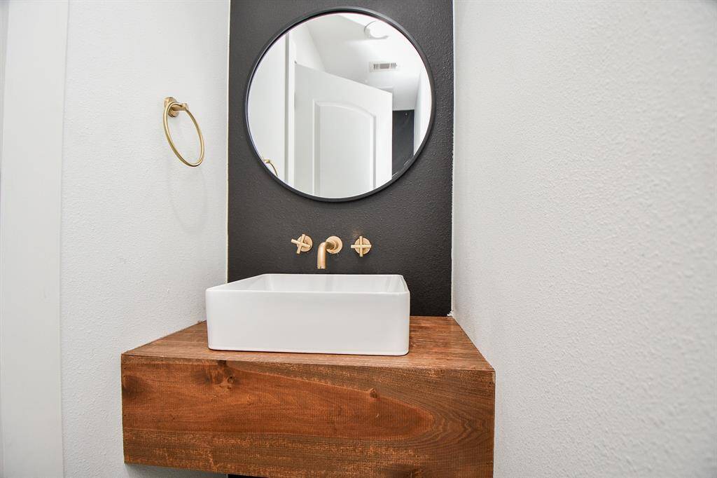 Stylish half bath with modern fixtures and a chic design.