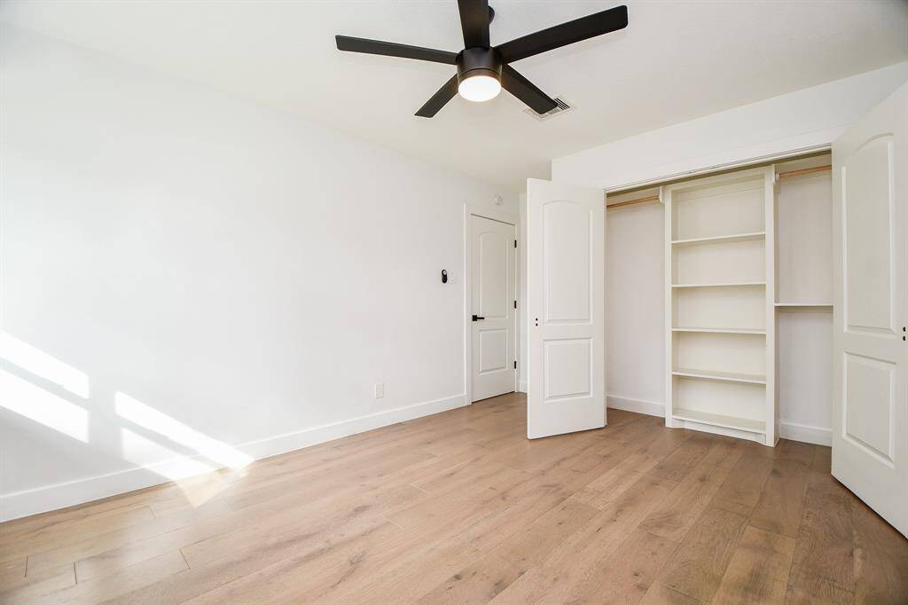 Discover a bright, airy bedroom featuring modern finishes, ample closet space, and sleek hardwood floors, perfect for relaxation.