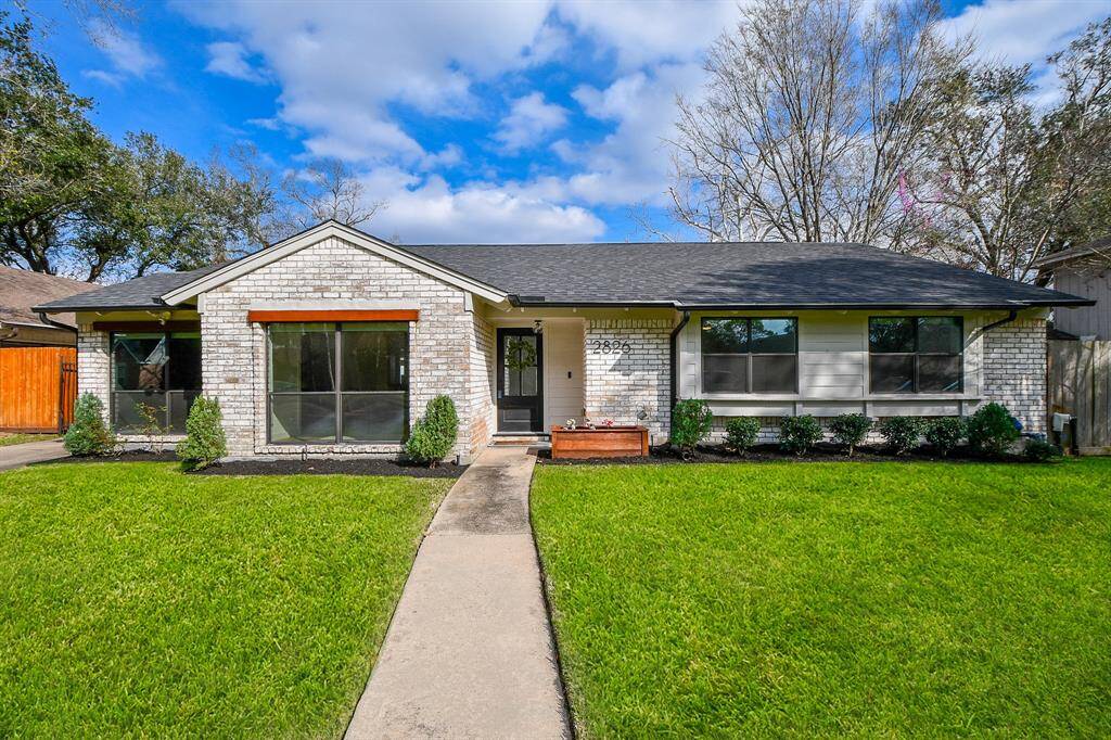 Charming single-story home with a welcoming front entrance, lush lawn, and tasteful landscaping. Perfect for comfortable living.