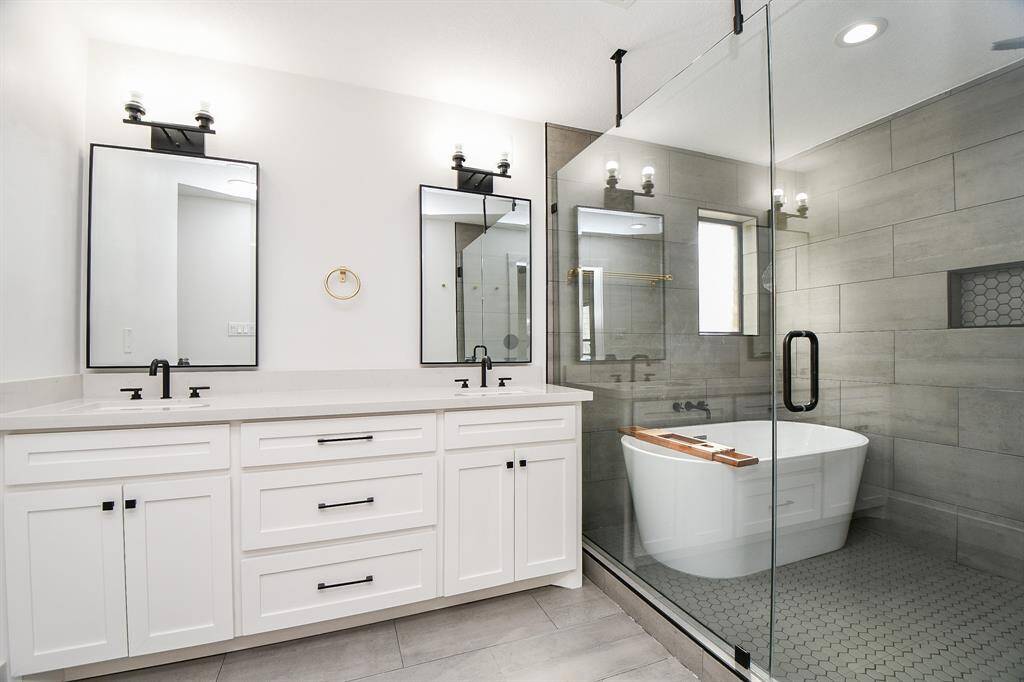 Experience the convenience and luxury of dual sinks in this elegant bathroom.