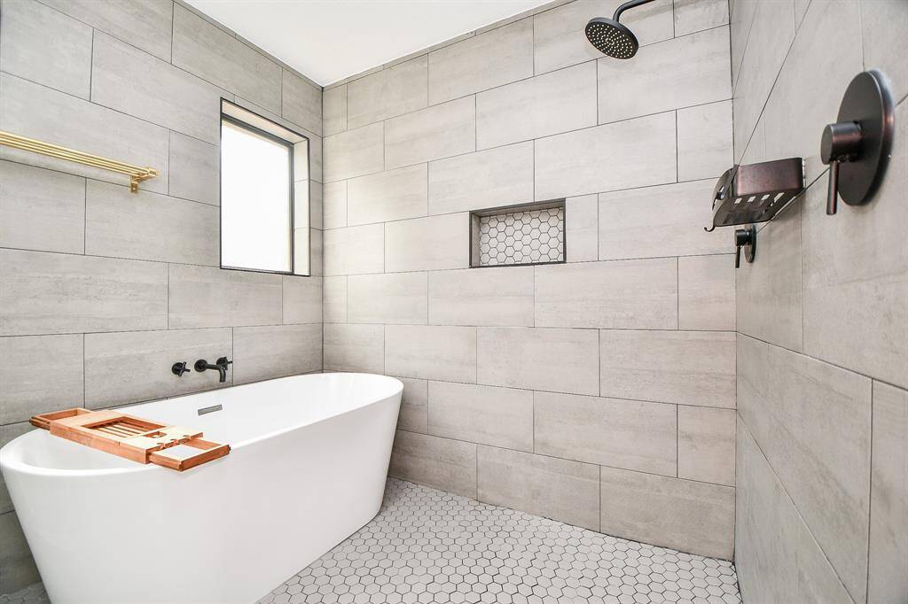 Luxurious bathroom featuring a spacious shower and a relaxing soaking tub.